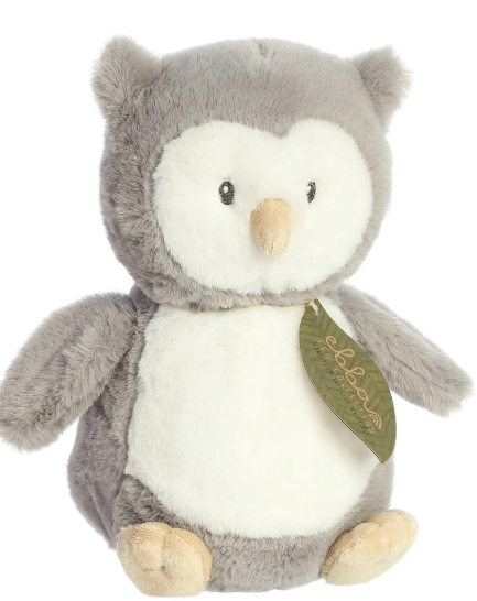 Plush owl toy with a green tag on a white background