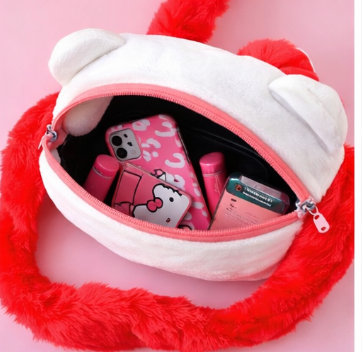 Red plush bag with a white interior, containing pink items on a pink background