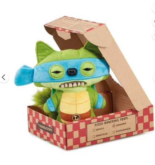 Plush toy resembling a character from 'Teenage Mutant Ninja Turtles' in a box with a pizza-themed design.